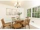 Bright dining area featuring a glass table, wooden chairs, and white walls at 535 Silver Pine Trl, Roswell, GA 30076