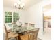 Bright dining room with modern table, chairs, and view of a well-lit room at 535 Silver Pine Trl, Roswell, GA 30076
