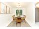 Dining room featuring a glass table, wood chairs, and modern lighting fixture at 535 Silver Pine Trl, Roswell, GA 30076