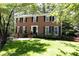 Traditional two-story brick home with well-manicured lawn and mature trees at 535 Silver Pine Trl, Roswell, GA 30076