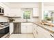Updated kitchen with white cabinets, stainless steel appliances, and granite counters at 535 Silver Pine Trl, Roswell, GA 30076