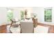 Well-lit living room with a desk area, seating, and large windows overlooking greenery at 535 Silver Pine Trl, Roswell, GA 30076