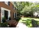 Brick home with black shutters, beautiful landscaping, and a green, grassy lawn at 535 Silver Pine Trl, Roswell, GA 30076