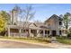 Charming clubhouse with stone tower, large porch, and manicured landscaping provides a comfortable community space at 4615 Kilmersdon Ln, Suwanee, GA 30024