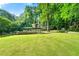 Expansive backyard with manicured lawn, spacious deck, and privacy fence perfect for outdoor enjoyment at 4882 Rock Haven Sw Dr, Lilburn, GA 30047
