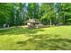 A lovely manicured lawn spans the rear of the house, with a large open space for endless possibilities at 4882 Rock Haven Sw Dr, Lilburn, GA 30047