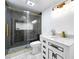 Modern bathroom featuring black tile shower with glass door and sleek vanity with gold fixtures at 4882 Rock Haven Sw Dr, Lilburn, GA 30047