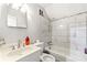 Bathroom featuring a shower-tub combination with white subway tile, a vanity, and neutral walls at 4882 Rock Haven Sw Dr, Lilburn, GA 30047