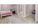 Spacious bedroom with tile floors, neutral wall color, and a view into an adjoining room at 4882 Rock Haven Sw Dr, Lilburn, GA 30047