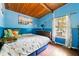 Cozy bedroom with tongue and groove ceiling and an abundance of natural light at 4882 Rock Haven Sw Dr, Lilburn, GA 30047