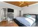 Well-lit bedroom with hardwood floors and a modern dresser, with an en-suite bathroom at 4882 Rock Haven Sw Dr, Lilburn, GA 30047
