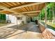 Carport featuring a concrete floor, brick wall, and wood ceiling at 4882 Rock Haven Sw Dr, Lilburn, GA 30047