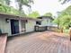 Wooden outdoor deck featuring a built-in bench, exterior lights, and ample space for relaxation at 4882 Rock Haven Sw Dr, Lilburn, GA 30047