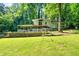 Charming home featuring a spacious front yard, covered patio, and complemented by the natural beauty of mature trees at 4882 Rock Haven Sw Dr, Lilburn, GA 30047