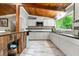 Bright kitchen featuring stainless steel appliances, white cabinets, and a large window for natural light at 4882 Rock Haven Sw Dr, Lilburn, GA 30047