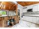 Bright kitchen featuring white cabinets, black countertops, mosaic backsplash, and vaulted wood ceilings at 4882 Rock Haven Sw Dr, Lilburn, GA 30047