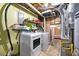 Functional laundry room with washer, dryer, and additional storage space, located in the basement at 4882 Rock Haven Sw Dr, Lilburn, GA 30047