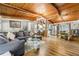 Spacious room featuring hardwood floors, a wood ceiling, and a dining room that transitions into the kitchen at 4882 Rock Haven Sw Dr, Lilburn, GA 30047