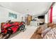 Open-concept living room with white tile floors, comfortable seating, and a bar area at 4882 Rock Haven Sw Dr, Lilburn, GA 30047