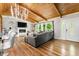 Stylish living room with hardwood floors, a white fireplace, and a wood-beam ceiling with a modern light fixture at 4882 Rock Haven Sw Dr, Lilburn, GA 30047