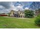 Expansive backyard view featuring a two-story home with a deck and lush lawn at 116 Laurel Ln, Social Circle, GA 30025