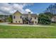 Exterior of home from the backyard, showcasing the deck and landscaped lawn at 116 Laurel Ln, Social Circle, GA 30025