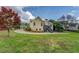 Large backyard with mature trees and green grass, featuring a second-story deck on the house at 116 Laurel Ln, Social Circle, GA 30025