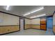 Spacious basement with paneling, drop ceiling, and ample lighting, adaptable for various uses like recreation or storage at 116 Laurel Ln, Social Circle, GA 30025