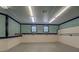 Spacious basement featuring painted walls, paneled walls and bright fluorescent lighting at 116 Laurel Ln, Social Circle, GA 30025