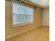 Bedroom with window bringing in ample sunlight, neutral walls, baseboards, and vinyl flooring at 116 Laurel Ln, Social Circle, GA 30025