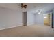 Spacious bedroom with neutral carpet, ceiling fans, and attached closet with window at 116 Laurel Ln, Social Circle, GA 30025