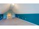 Bedroom features blue accent walls and sloped ceilings at 116 Laurel Ln, Social Circle, GA 30025