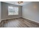 Bedroom features laminate floors and a view of the front yard at 116 Laurel Ln, Social Circle, GA 30025