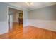 Dining room featuring decorative chair rail and trim and hardwood flooring, leading into kitchen area at 116 Laurel Ln, Social Circle, GA 30025