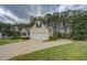 Exterior of a home with well-manicured front yard, landscaping and concrete driveway at 116 Laurel Ln, Social Circle, GA 30025