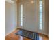 Bright foyer with hardwood floors, white door, and decorative rug at 116 Laurel Ln, Social Circle, GA 30025