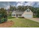 Charming home with a manicured lawn, landscaping, and a two-car garage at 116 Laurel Ln, Social Circle, GA 30025