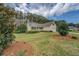 Charming home featuring a landscaped front yard, mature trees, and a well-manicured lawn at 116 Laurel Ln, Social Circle, GA 30025