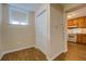 Hallway with a closet, wood flooring, and a view of the kitchen at 116 Laurel Ln, Social Circle, GA 30025