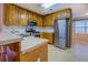 Kitchen featuring stainless steel appliances, wood cabinets, and bright natural light from the nearby window at 116 Laurel Ln, Social Circle, GA 30025