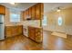 Kitchen with wood cabinets, laminate flooring, and an open view of front entrance at 116 Laurel Ln, Social Circle, GA 30025