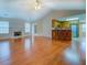 Spacious living room with a fireplace, vaulted ceilings, hardwood floors and an open view of the kitchen at 116 Laurel Ln, Social Circle, GA 30025