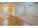 Living room with laminate flooring, ceiling fan and an open view of front entrance at 116 Laurel Ln, Social Circle, GA 30025