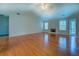 Spacious living room with hardwood floors, fireplace, and plenty of natural light at 116 Laurel Ln, Social Circle, GA 30025