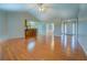 Open concept living space with hardwood floors, bar seating, and a view of the foyer at 116 Laurel Ln, Social Circle, GA 30025