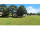 Spacious backyard surrounded by mature trees and greenery at 152 Ridge Xing, Temple, GA 30179