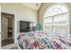 Bright bedroom features large arched window, and closet at 152 Ridge Xing, Temple, GA 30179