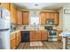 Efficient kitchen layout with stainless steel appliances, wood cabinetry, and durable vinyl flooring at 152 Ridge Xing, Temple, GA 30179