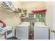 Laundry room features shelving and washer and dryer at 152 Ridge Xing, Temple, GA 30179