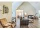 Bright living room with vaulted ceilings flows into the dining area and kitchen, enhancing the open layout at 152 Ridge Xing, Temple, GA 30179